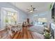 Bright dining area featuring a chandelier, hardwood floors, and views of the backyard at 9375 French Quarters Cir, Weeki Wachee, FL 34613