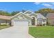 Charming home with well-maintained lawn, landscaping, and a two-car garage at 9375 French Quarters Cir, Weeki Wachee, FL 34613