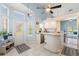 Bright kitchen featuring an island with extra seating, tile floors, and white cabinetry at 9375 French Quarters Cir, Weeki Wachee, FL 34613