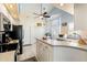 Bright kitchen with an island, white cabinets, and stainless steel appliances at 9375 French Quarters Cir, Weeki Wachee, FL 34613