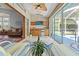 Enclosed lanai with wet bar, mini-refrigerator, and view of screened pool and backyard at 9375 French Quarters Cir, Weeki Wachee, FL 34613