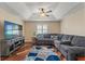 Living room featuring a plush sofa, stylish decor, and an entertainment center at 9375 French Quarters Cir, Weeki Wachee, FL 34613