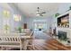 Spacious living room with fireplace, ceiling fan, and sliding glass doors leading to the pool area at 9375 French Quarters Cir, Weeki Wachee, FL 34613