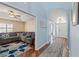 Open-concept living room features vaulted ceiling, wood floors, and lots of natural light at 9375 French Quarters Cir, Weeki Wachee, FL 34613