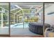 View of the pool and hot tub from screened lanai at 9375 French Quarters Cir, Weeki Wachee, FL 34613