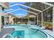 Screened-in pool area with chairs and table provides a relaxing outdoor oasis at 9375 French Quarters Cir, Weeki Wachee, FL 34613