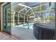 View of the pool and hot tub from screened lanai at 9375 French Quarters Cir, Weeki Wachee, FL 34613