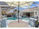 Screened-in pool area features a private pool, hot tub, and outdoor seating at 9375 French Quarters Cir, Weeki Wachee, FL 34613