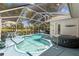 Enjoy a screened-in pool and hot tub with lush surroundings, perfect for relaxation and entertaining at 9375 French Quarters Cir, Weeki Wachee, FL 34613