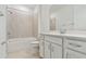 Well-lit bathroom featuring a shower-tub combo and vanity with sink at 9408 Coastline Way, Parrish, FL 34219
