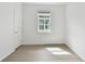 Bright bedroom featuring a window with blinds and wood flooring at 9408 Coastline Way, Parrish, FL 34219