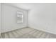 Cozy bedroom featuring a window with blinds and plush carpeting at 9408 Coastline Way, Parrish, FL 34219