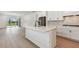 Open kitchen with stainless appliances, island, and view to the living area at 9408 Coastline Way, Parrish, FL 34219