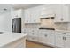 Close up of the modern kitchen featuring white cabinets and stainless steel appliances at 9408 Coastline Way, Parrish, FL 34219