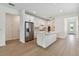 Bright, all-white kitchen featuring stainless steel appliances and a large island at 9408 Coastline Way, Parrish, FL 34219
