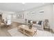 Bright, open-concept living room with modern furnishings and hardwood floors at 9408 Coastline Way, Parrish, FL 34219