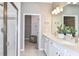 Well-lit bathroom with a double sink vanity, glass-enclosed shower, and modern fixtures at 9530 Coastline Way, Parrish, FL 34219