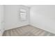 Bright bedroom featuring neutral carpet, light walls, and a sunny window at 9530 Coastline Way, Parrish, FL 34219