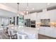 Modern kitchen featuring stainless steel appliances, a central island, and pendant lighting at 9530 Coastline Way, Parrish, FL 34219