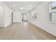 Spacious living room featuring neutral walls, wood-look tile flooring, recessed lighting, and ample natural light at 9530 Coastline Way, Parrish, FL 34219