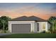 Charming single-Gathering home boasts a 2-car garage, verdant lawn, and tropical landscaping at 9534 Coastline Way, Parrish, FL 34219
