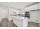 Modern kitchen with white cabinetry, a large island, and stainless-steel appliances at 9534 Coastline Way, Parrish, FL 34219