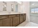 Bathroom featuring a double vanity with modern fixtures and a large mirror at 10317 Cross River Trl, Parrish, FL 34219