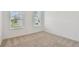 Cozy bedroom with plush carpeting and large windows allowing for lots of natural light at 10317 Cross River Trl, Parrish, FL 34219