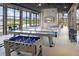 Fun game room with foosball, pool tables, and plenty of natural light, perfect for entertaining residents at 10317 Cross River Trl, Parrish, FL 34219