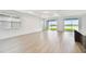 Open living space with scenic lake views, tray ceiling, and light hardwood floors for a modern, airy feel at 10317 Cross River Trl, Parrish, FL 34219