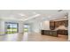 Bright and spacious living area that seamlessly connects to the kitchen, and scenic lake views through sliding glass doors at 10317 Cross River Trl, Parrish, FL 34219