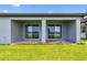 Covered patio with brick pavers overlooks a beautiful pond, creating a serene outdoor living space at 10317 Cross River Trl, Parrish, FL 34219