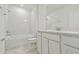 Bright bathroom featuring white subway tile, a shower-tub combo, and a granite vanity at 10414 Cross River Trl, Parrish, FL 34219