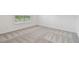 Neutral carpeted bedroom featuring white walls and a window for natural light at 10414 Cross River Trl, Parrish, FL 34219