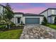 Charming single-Gathering home boasts a well-manicured lawn, a two-car garage, and elegant curb appeal at 10414 Cross River Trl, Parrish, FL 34219