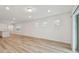 Modern living room showcasing wood-look floors, white walls, and ample natural light at 10414 Cross River Trl, Parrish, FL 34219