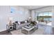 Cozy living room with modern decor, comfortable seating, and sliding doors leading to an outdoor space at 10414 Cross River Trl, Parrish, FL 34219