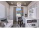Charming office with a decorative chandelier, bright window, and storage shelves for an organized workspace at 10414 Cross River Trl, Parrish, FL 34219