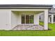 Covered patio features decorative brick flooring with sliding glass doors leading indoors at 10414 Cross River Trl, Parrish, FL 34219