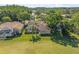 Aerial view of the home, surrounded by luscious landscaping and views of the golf course at 1084 Berkshire Ln, Tarpon Springs, FL 34688