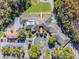 Beautiful community building featuring ample parking, mature trees, and well maintained green spaces at 1084 Berkshire Ln, Tarpon Springs, FL 34688