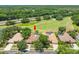Aerial view of the homes with a golf course view, private pools and lovely landscaping at 1084 Berkshire Ln, Tarpon Springs, FL 34688