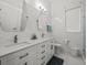 Modern bathroom featuring double sinks, marble tiling, and a glass-enclosed shower at 1084 Berkshire Ln, Tarpon Springs, FL 34688