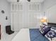 Bedroom with a bed, stylish seaside decor, fan, natural light, and tiled floors at 1084 Berkshire Ln, Tarpon Springs, FL 34688