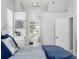 Bright bedroom featuring a luxurious soaking tub viewed through an arched doorway to the ensuite bathroom at 1084 Berkshire Ln, Tarpon Springs, FL 34688