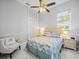 Bedroom with a bed, stylish seaside decor, fan, natural light, and tiled floors at 1084 Berkshire Ln, Tarpon Springs, FL 34688