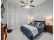 Comfortable bedroom featuring nautical themed decor, a ceiling fan, and ample closet space at 1084 Berkshire Ln, Tarpon Springs, FL 34688