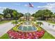 Community entrance with water feature, flag pole, and beautiful landscaping at 1084 Berkshire Ln, Tarpon Springs, FL 34688