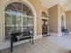 Bright entryway with large windows, tiled floors, and decorative door wreaths at 1084 Berkshire Ln, Tarpon Springs, FL 34688