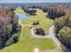 Beautiful aerial of a golf course surrounded by gorgeous trees at 1084 Berkshire Ln, Tarpon Springs, FL 34688